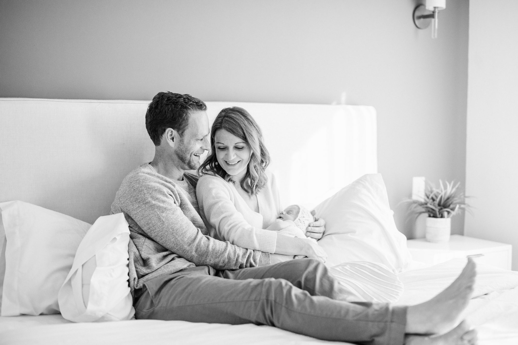 Black and white portrait of parents holding baby during newborn session in Chevy Chase DC. Photo by LRG Portraits