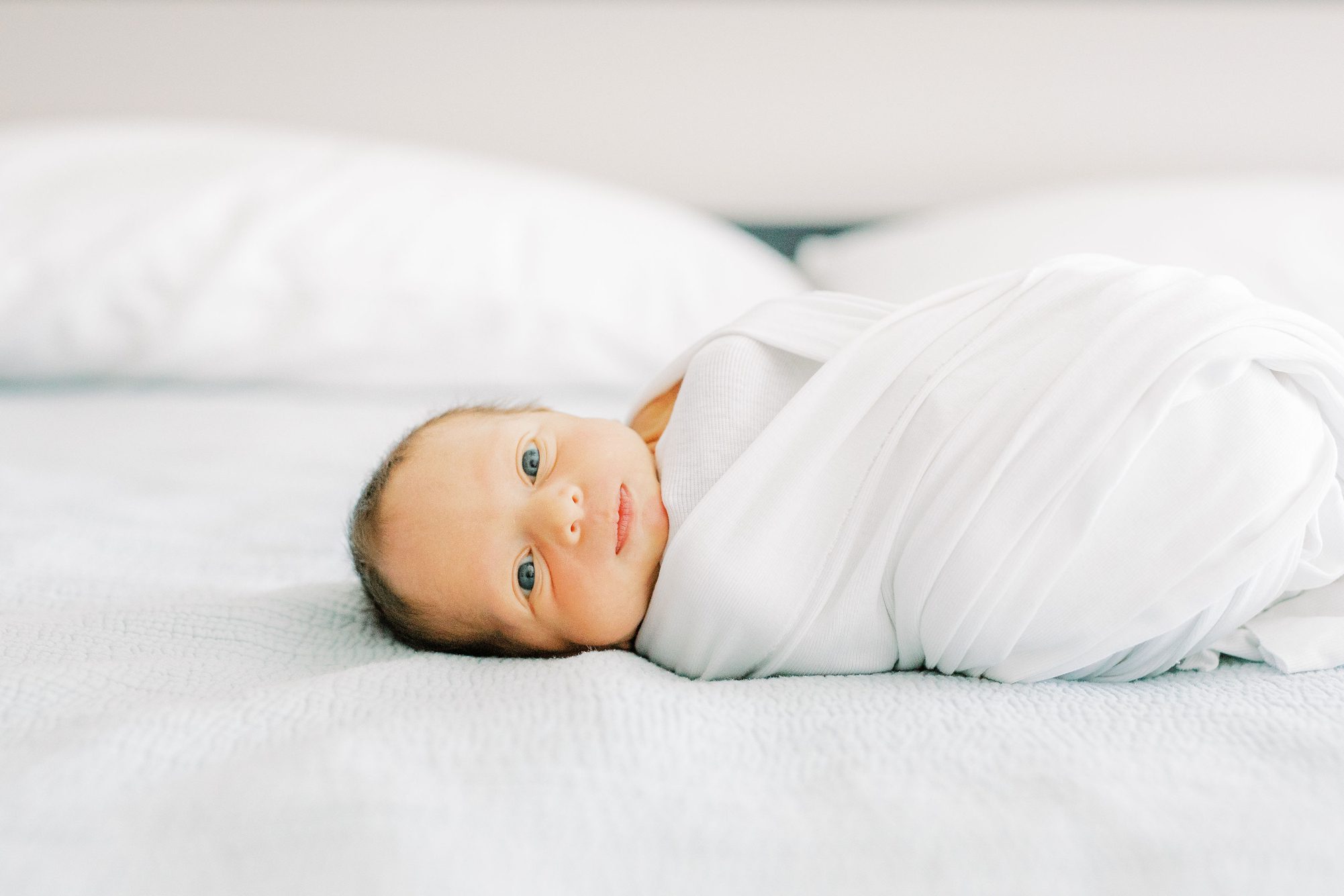 Sweet awake baby boy during newborn session in Washington DC. Photo by LRG Portraits