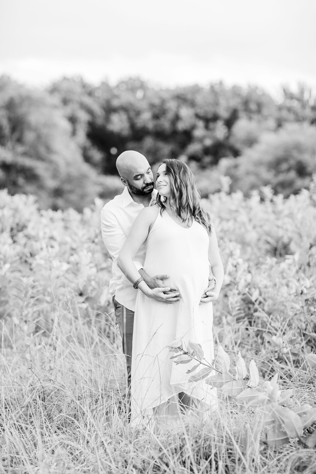 Black and white image of parents during maternity session. Photo by LRG Portraits.
