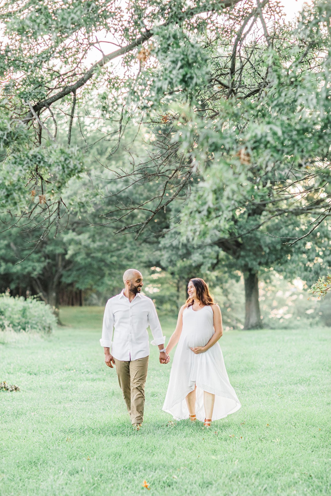 Mom and Dad walking during maternity session. Photo by Washington DC photographer, LRG Portraits