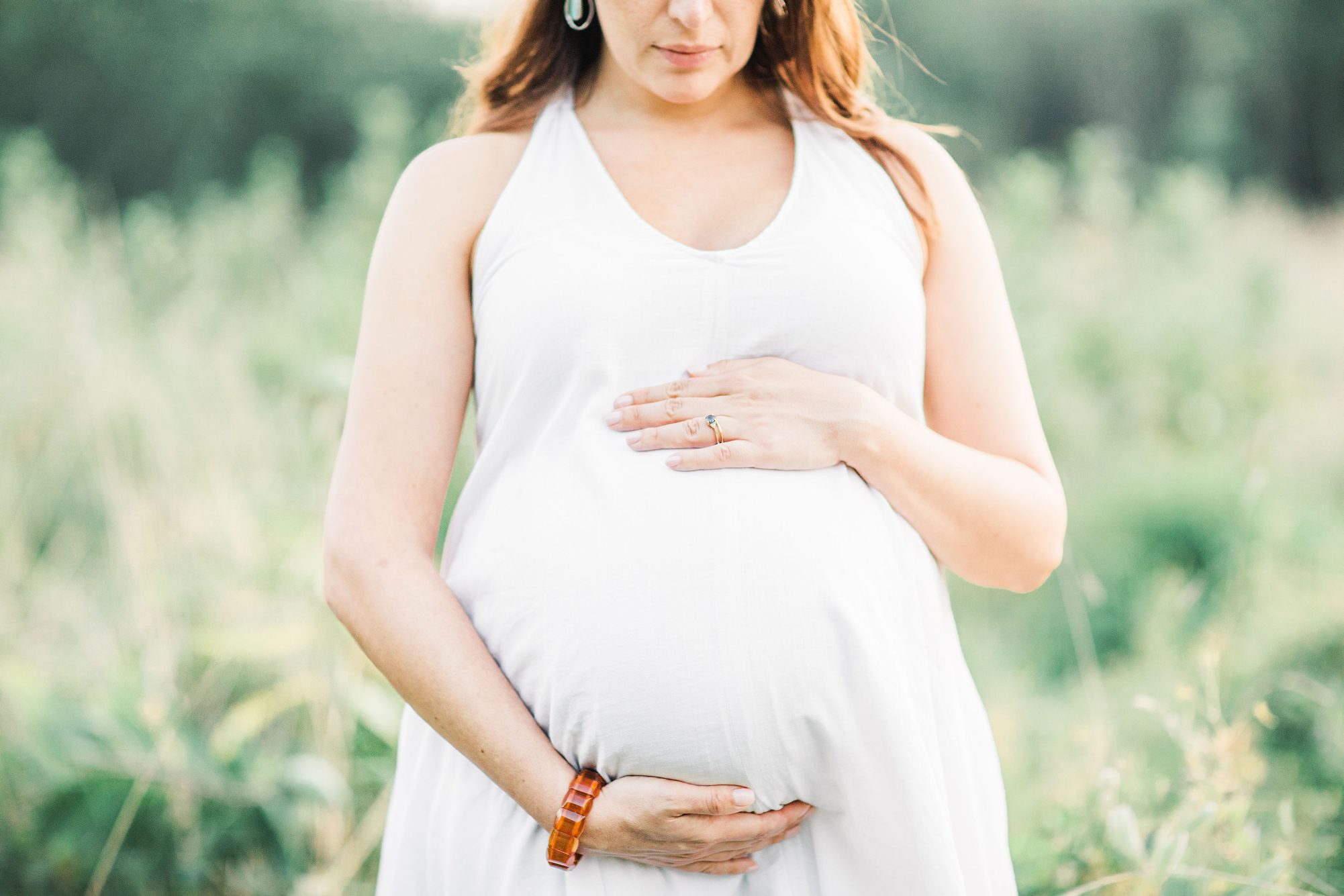 Closeup of Mom's bump during maternity session. Photo by LRG Portraits