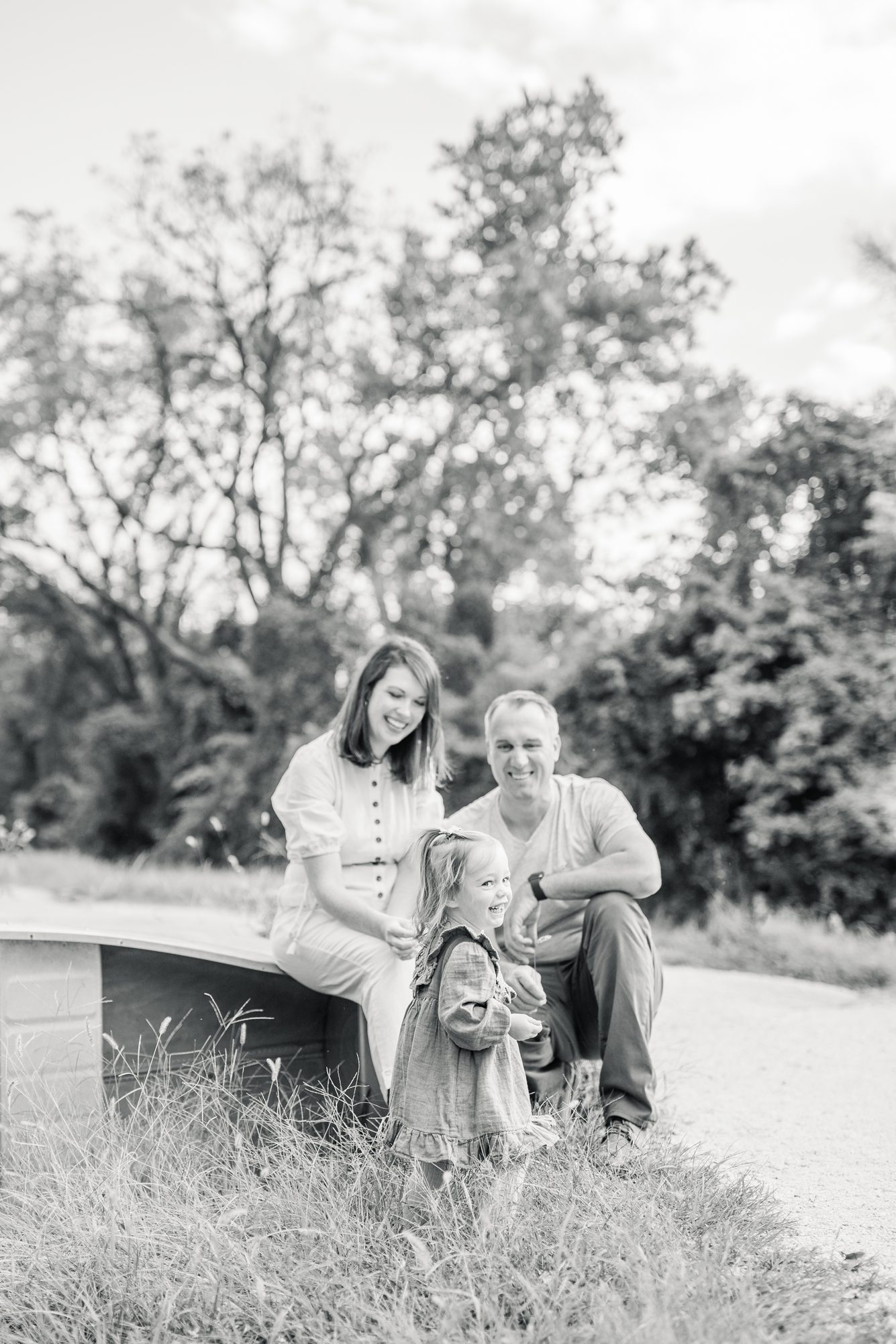 Black and white portrait of family laughing with toddler by Washington DC family photographer, LRG Portraits.