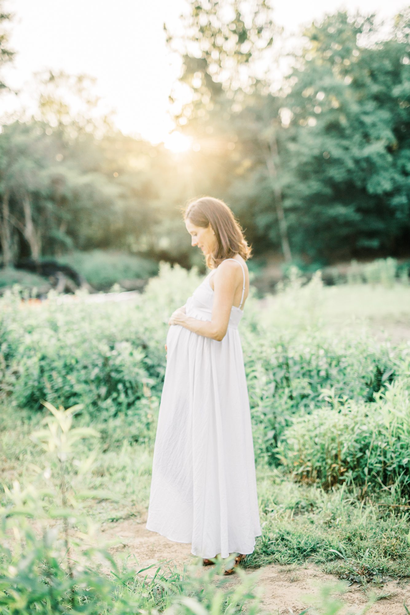 Dreamy maternity portrait from park by the Potomac River in Washington DC. Photo by LRG Portraits.
