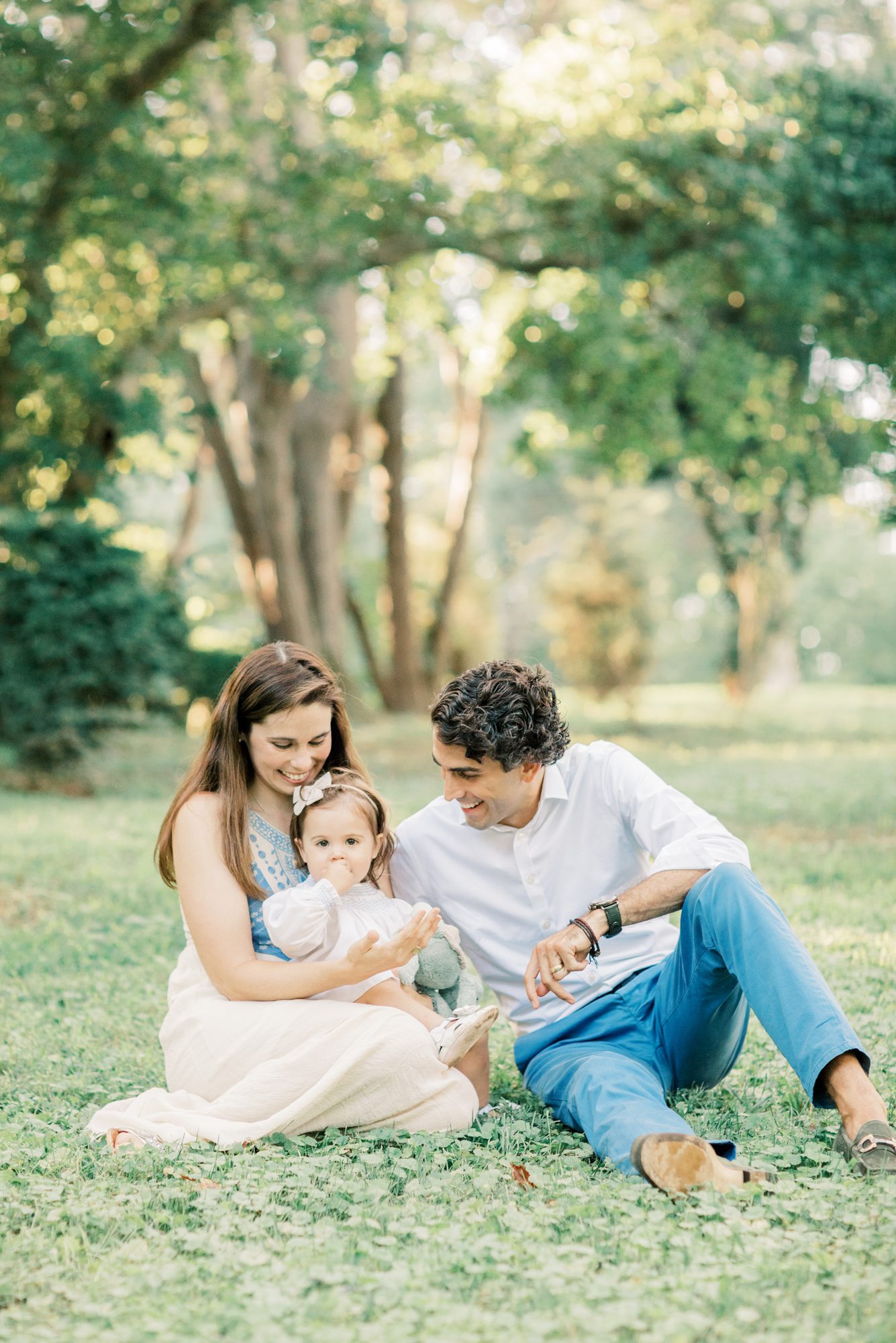 Family cuddling on grass at Woodend Sanctuary and Mansion during family photoshoot. Photo by LRG Portraits.