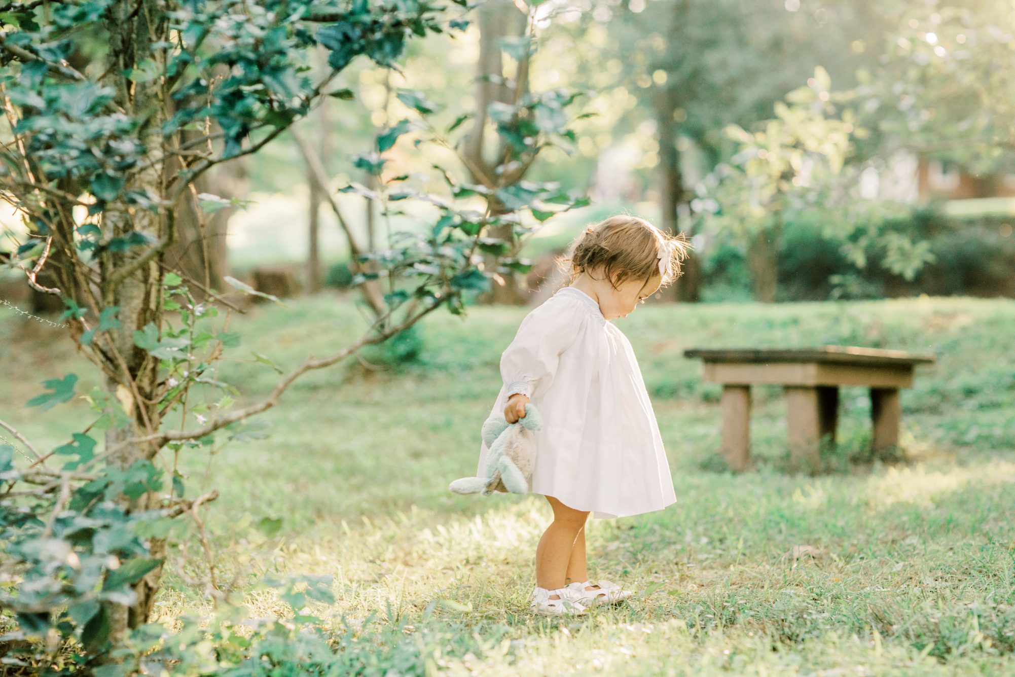 Little girl exploring during family portrait session in Chevy Chase MD. Photo by LRG Portraits.