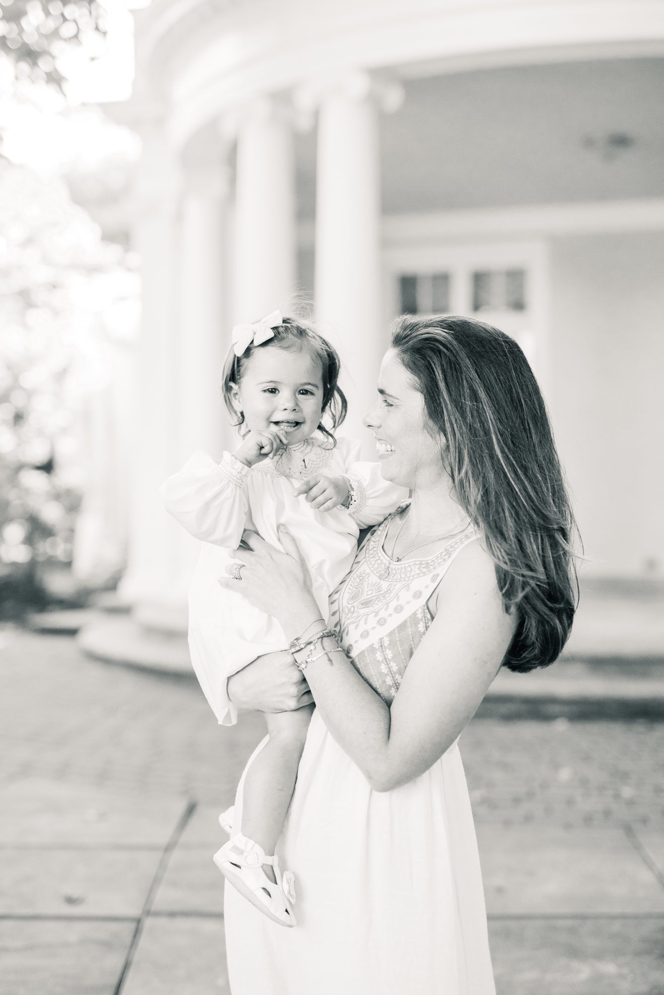 Black and white portrait of Mom holding toddler during session. Photo by LRG Portraits.