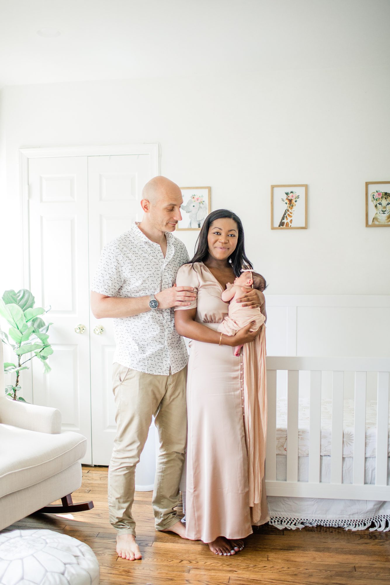 Beautiful portrait of new family of three during lifestyle newborn session Photo by LRG Portraits.