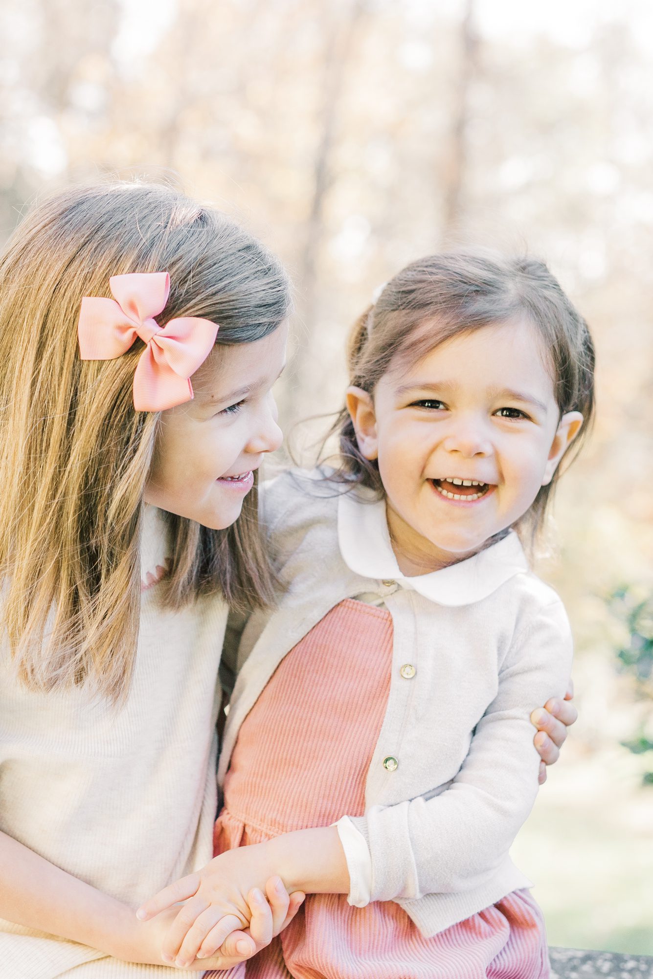 Closeup of sisters smiling during family photoshoot in Washington DC. Photo by LRG Portraits.